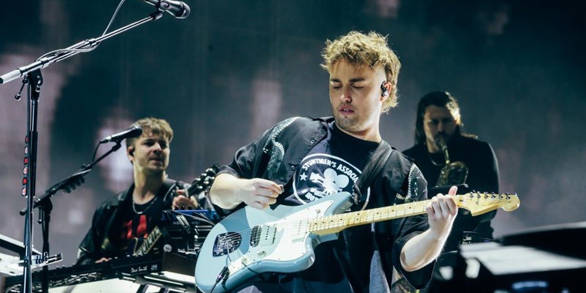 Sam Fender plays an electric guitar onstage at Reading Festival in 2023.