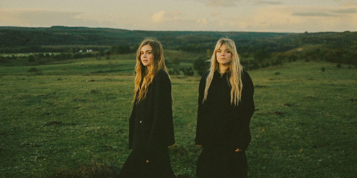 Archive publicity photograph of First Aid Kit's Johanna and Klara Soderberg outdoors.